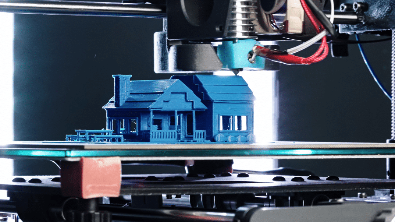 3D printer printing a house sculpture in blue filament